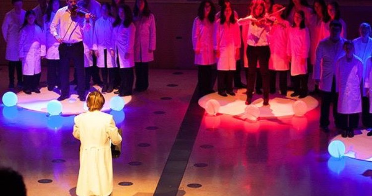 Neil Harbisson conducting musicians with color